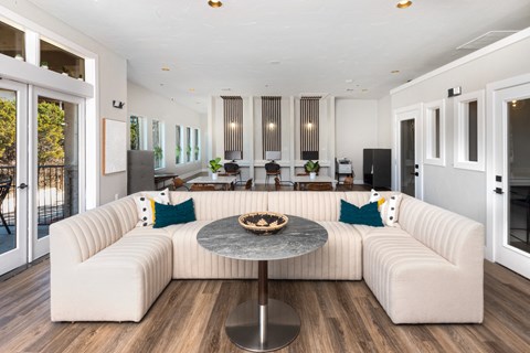 a living room with a white couch and a round table